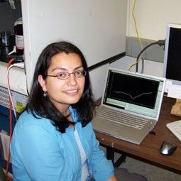 Woman with shoulder length black hair and glasses