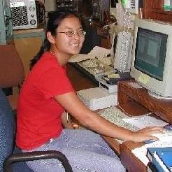 Woman with long black hair pulled into a ponytail and glasses