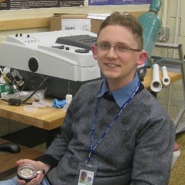 Man with short light brown hair and glasses