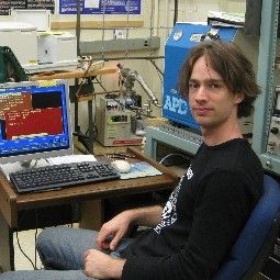 Man with brown hair long enough to cover his ears