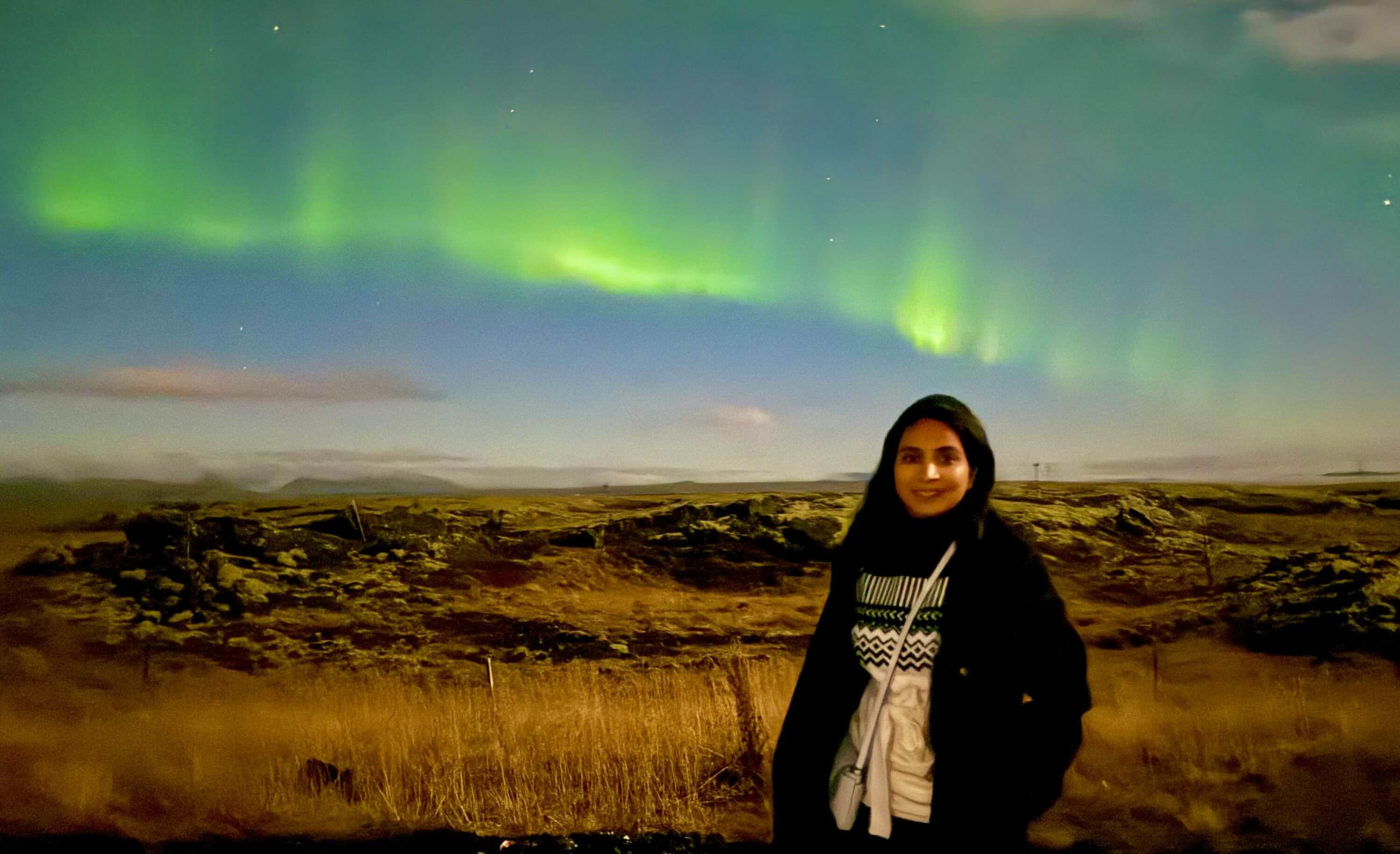 The left photo depicts the Northern Lights, or Aurora Borealis, illuminating the background in Iceland. The photo on the right features two white lions in the national reserve near Johannesburg, South Africa. 