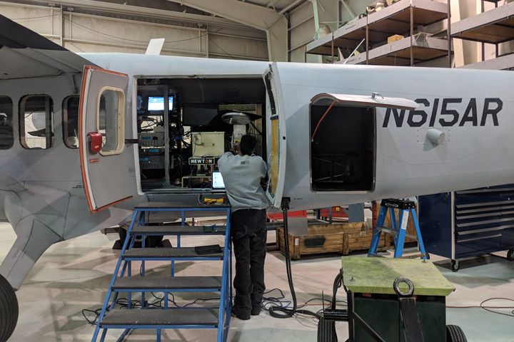 Photo of personnel making final check of SWESARR radiometer on aircraft